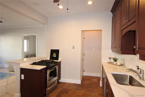a kitchen that has a sink and a stove