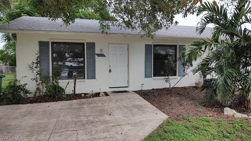 585 106th Avenue North Naples, FL 34108 - Photo 1 of 15 a front view of a house with a yard