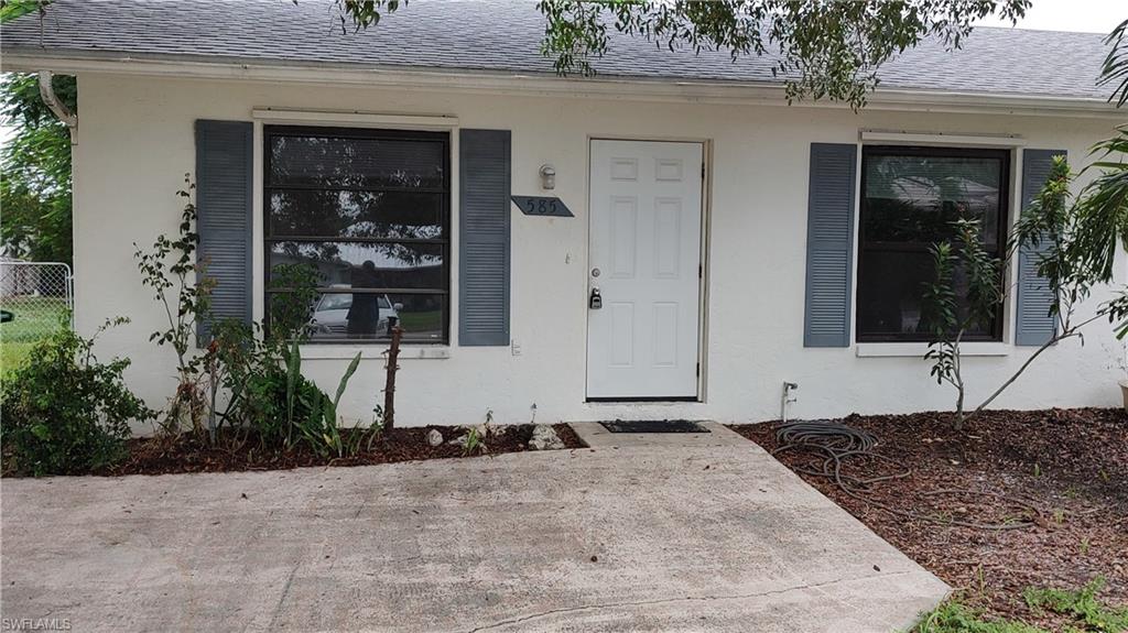 585 106th Avenue North Naples, FL 34108 - Photo 15 of 15 a front view of a house with a yard