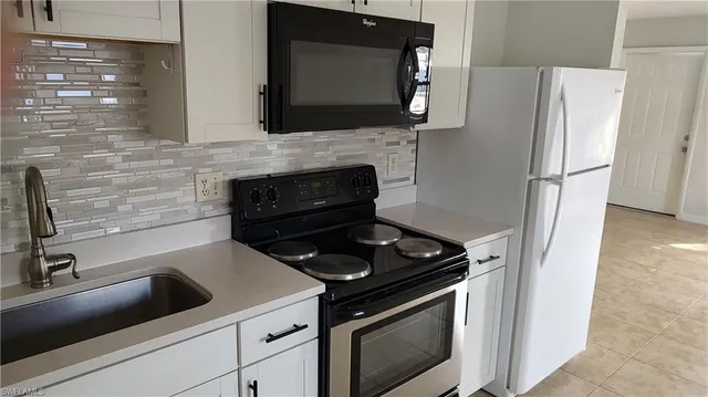 a kitchen with a stove and a microwave