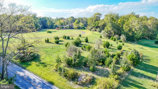 an aerial view of residential house with outdoor space and swimming pool
