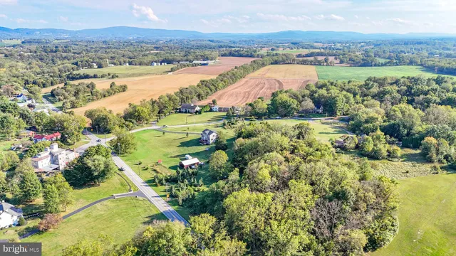 an aerial view of lake and residential houses with outdoor space