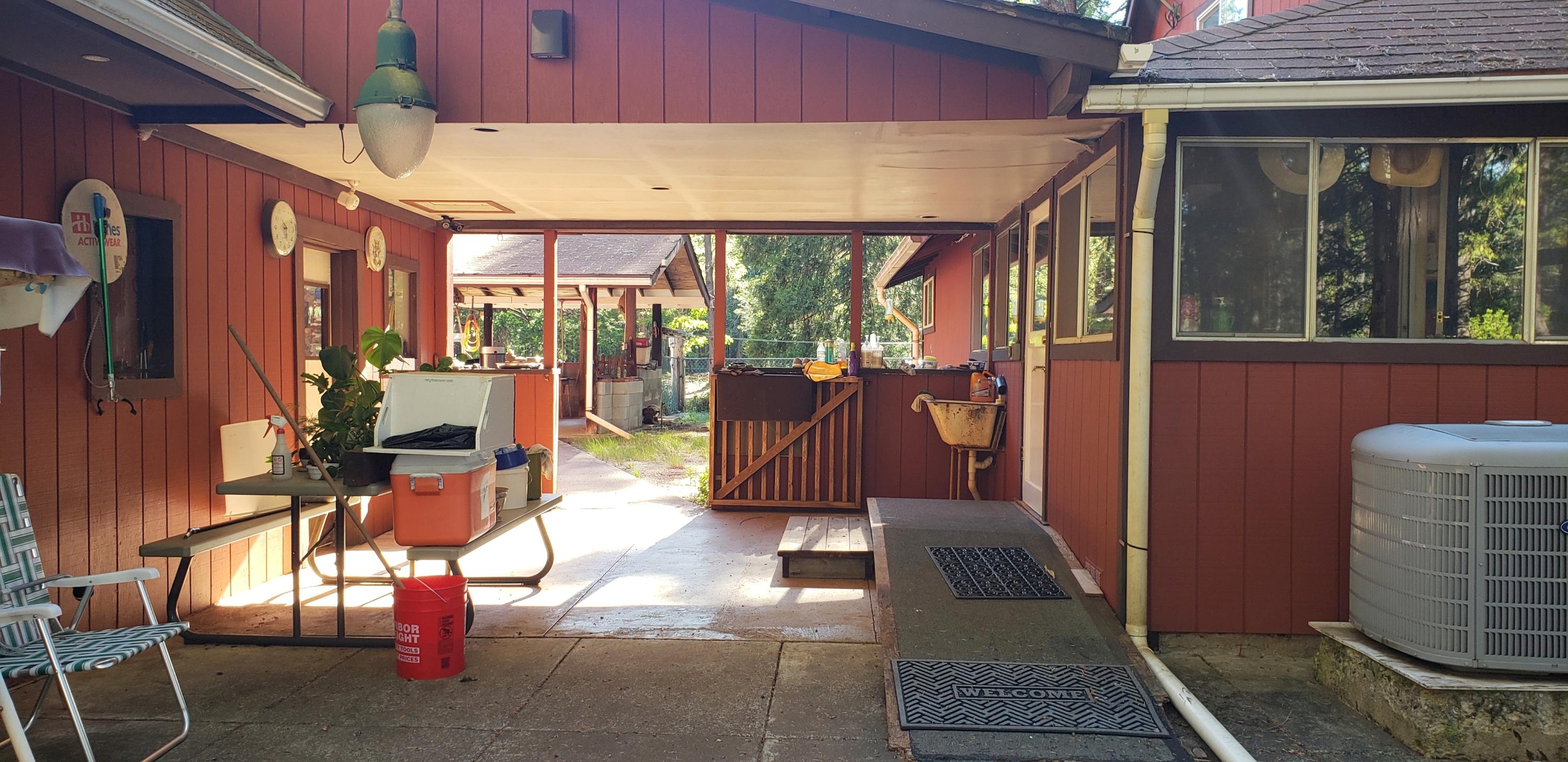 1200 Rough And Ready Creek Road Cave Junction, OR 97523 - Photo 4 of 40 conc. floor, breezeway from home to gara
