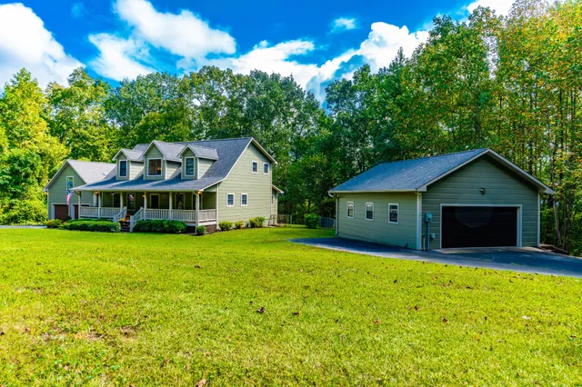 a view of staircase with lots of frames on wall and wooden floor