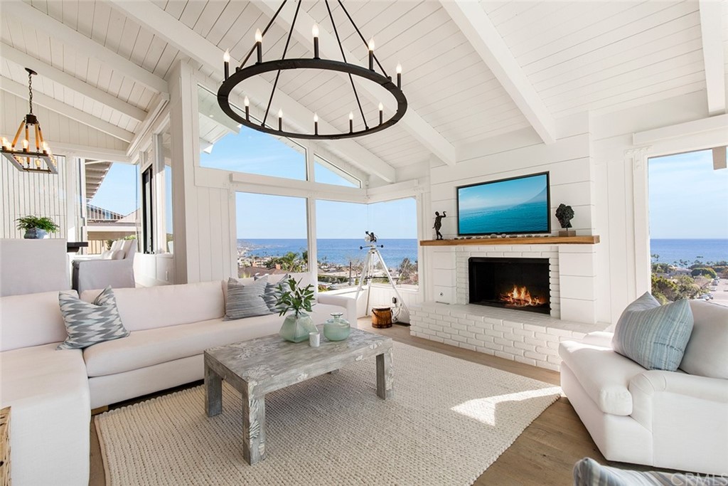 345 Heather Place Laguna Beach, CA 92651 - Photo 15 of 41 a living room with furniture a fireplace and a large window