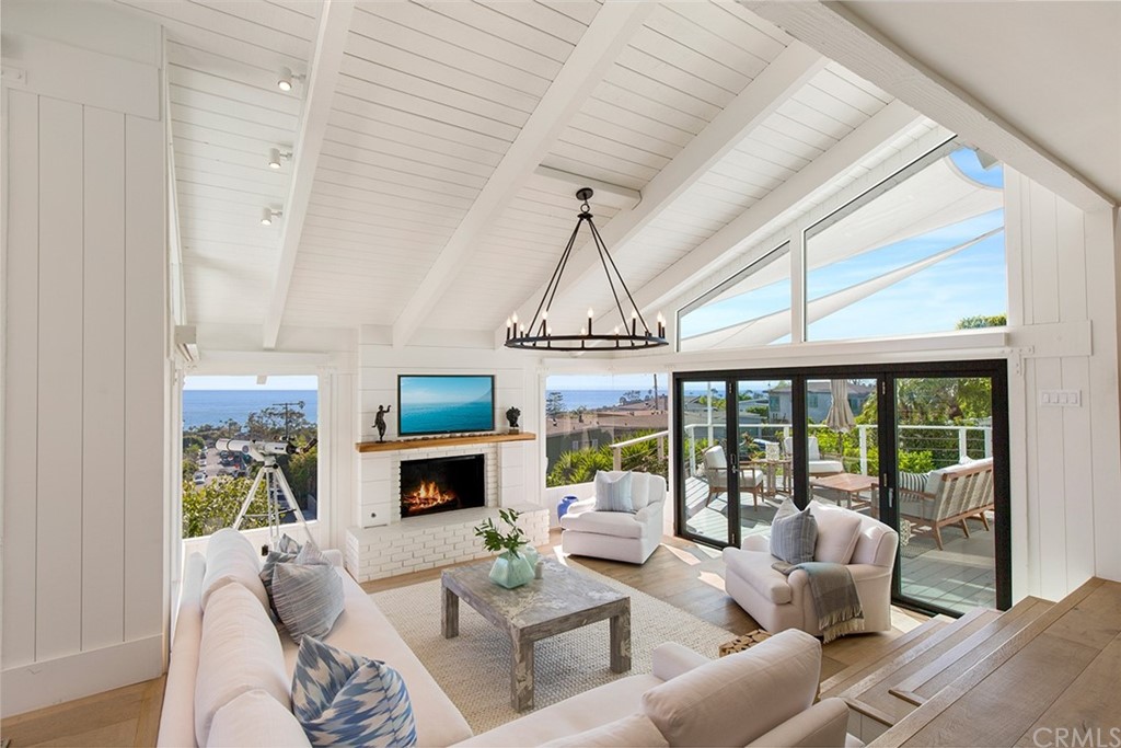 345 Heather Place Laguna Beach, CA 92651 - Photo 16 of 41 a living room with furniture fireplace and a large window