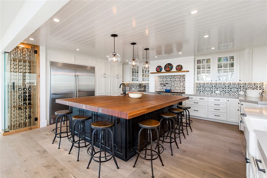 345 Heather Place Laguna Beach, CA 92651 - Photo 20 of 41 a open kitchen with stainless steel appliances a table and chairs in it