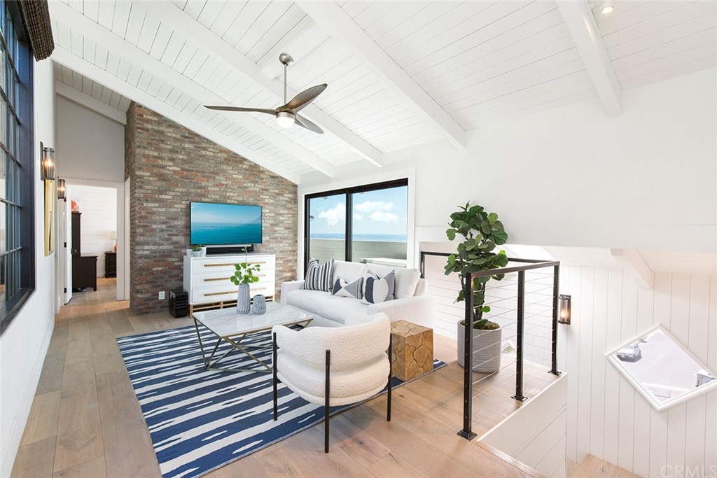 345 Heather Place Laguna Beach, CA 92651 - Photo 30 of 41 a living room with furniture a flat screen tv and a large window