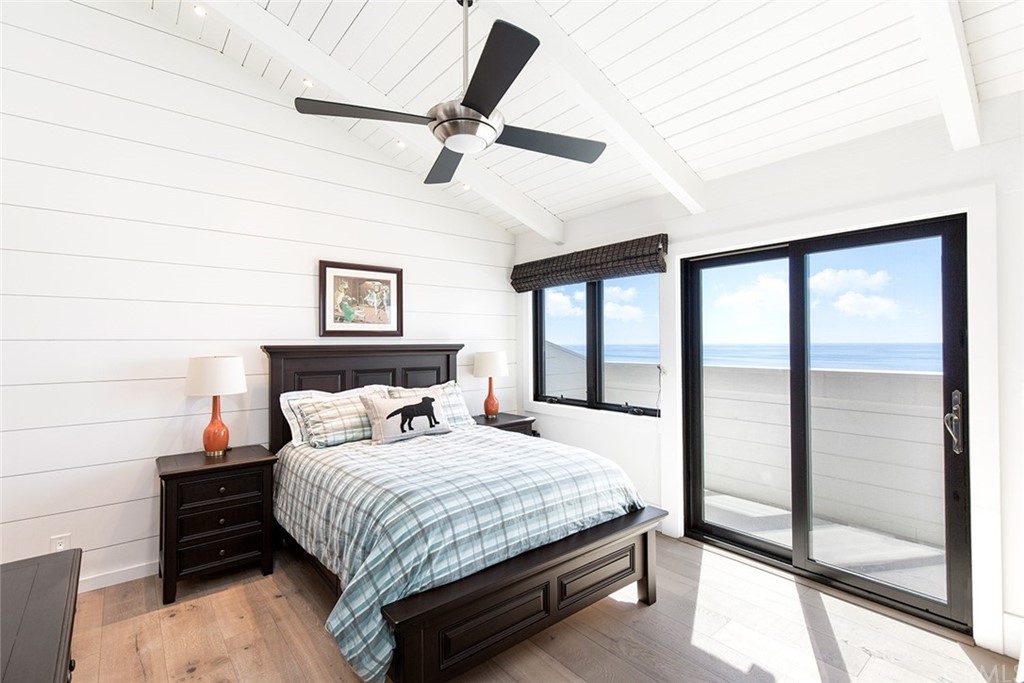 345 Heather Place Laguna Beach, CA 92651 - Photo 34 of 41 a bedroom with a bed and large window