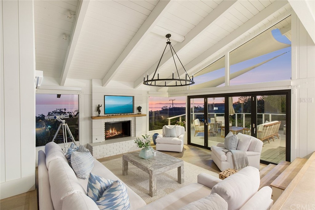 345 Heather Place Laguna Beach, CA 92651 - Photo 5 of 41 a living room with furniture a fireplace and a flat screen tv