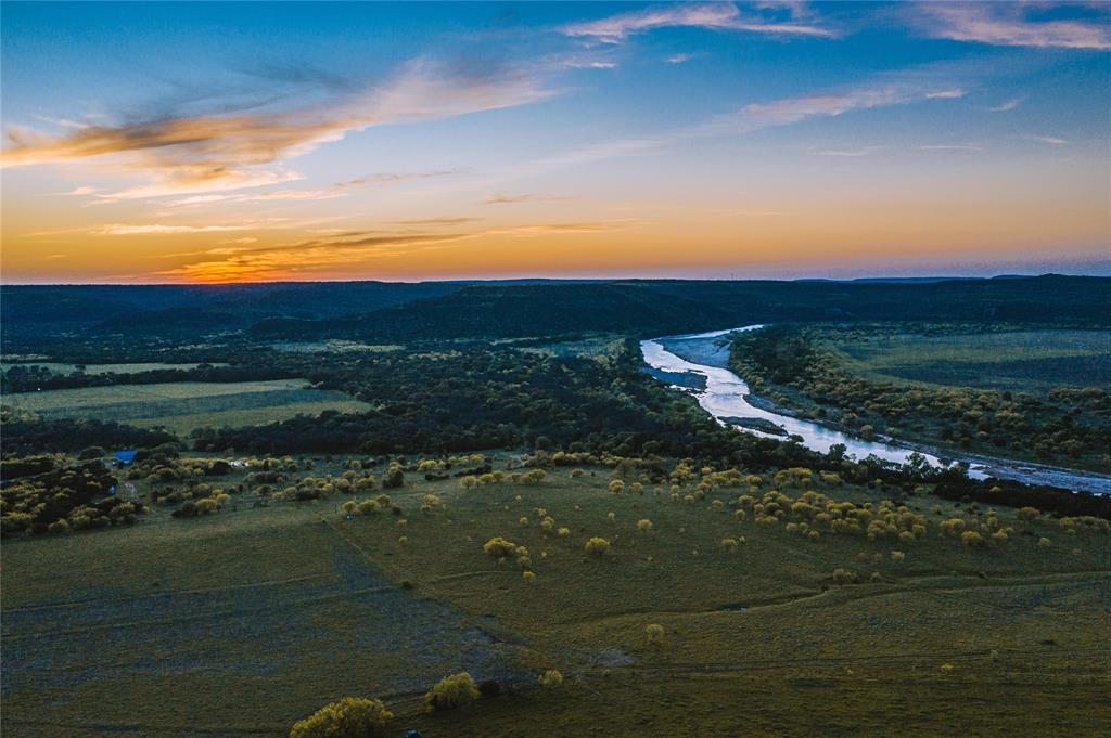 a sunset view with a lake