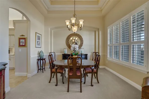 a view of a dining room with furniture and chandelier