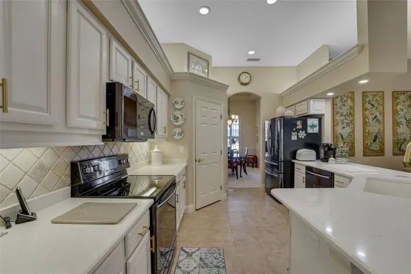 a kitchen with a sink appliances and cabinets