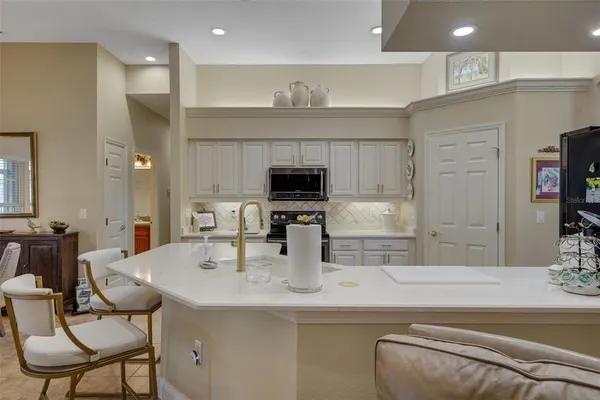 a kitchen with stainless steel appliances kitchen island granite countertop a sink and cabinets