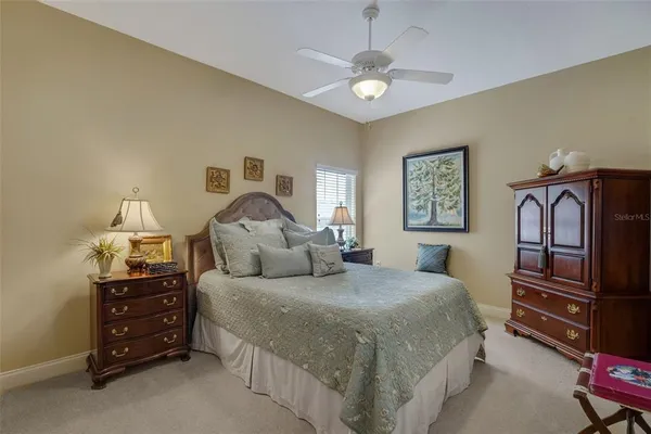 a bedroom with a bed and dresser