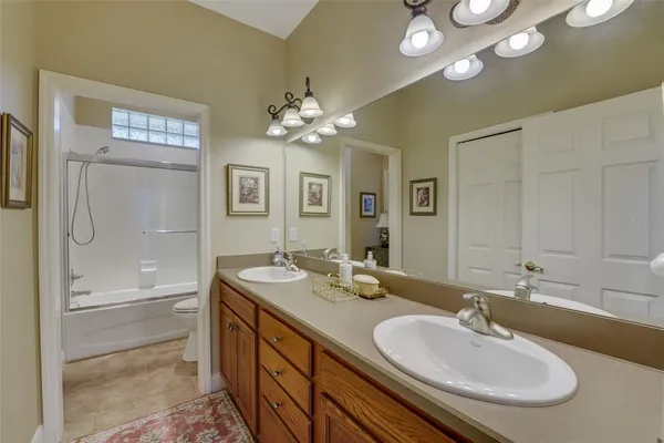 a bathroom with a double vanity sink and a mirror