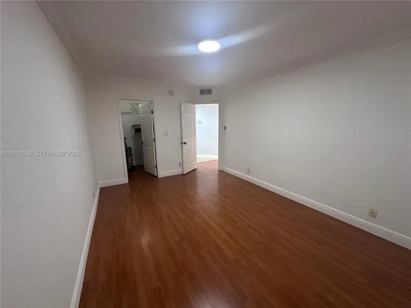 a view of a room with wooden floor and window