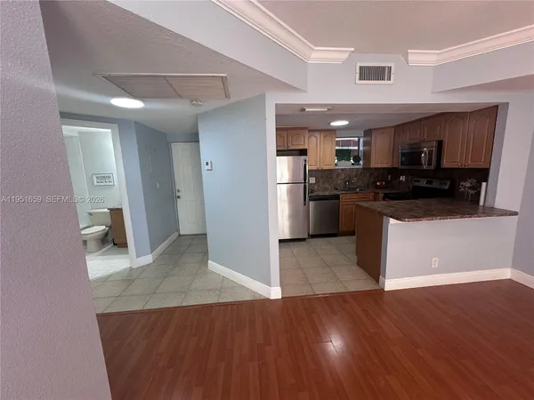 a kitchen with stainless steel appliances granite countertop a stove and a refrigerator