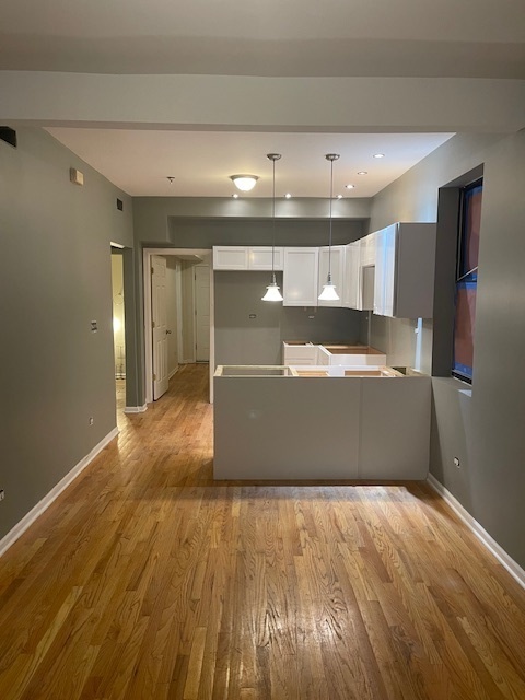 2620 West 24th Street Chicago, IL 60608 - Photo 17 of 25 a view of a refrigerator in kitchen and wooden floor