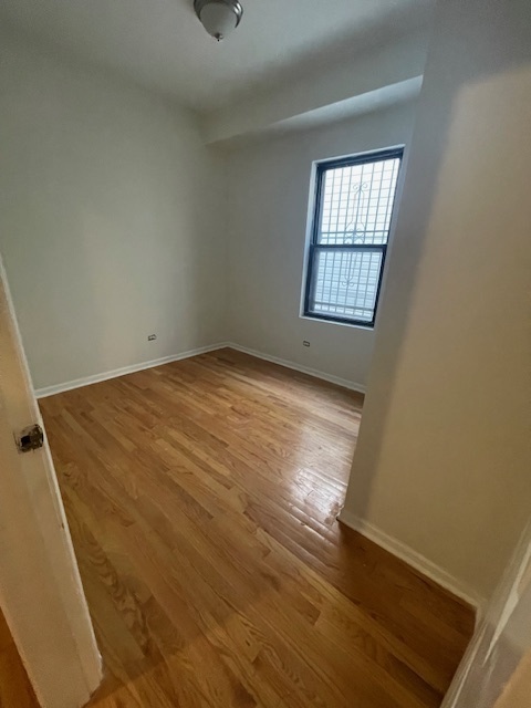 2620 West 24th Street Chicago, IL 60608 - Photo 18 of 25 an empty room with wooden floor and windows