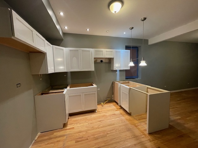 2620 West 24th Street Chicago, IL 60608 - Photo 25 of 25 a kitchen with a cabinets and wooden floor