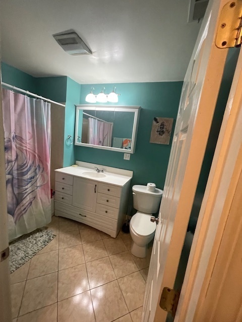 2620 West 24th Street Chicago, IL 60608 - Photo 7 of 25 a bathroom with a sink a toilet a mirror and shower
