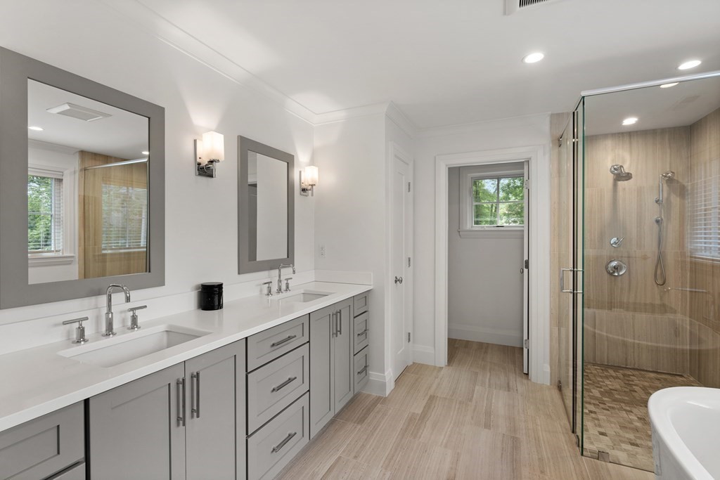 76 Paulson Road Newton, MA 02468 - Photo 23 of 41 a bathroom with a double vanity sink a mirror and a shower