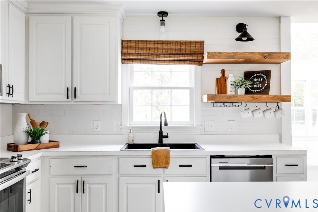 16044 Parsons Road Beaverdam, VA 23015 - Photo 15 of 44 a kitchen with stainless steel appliances a stove and white cabinets