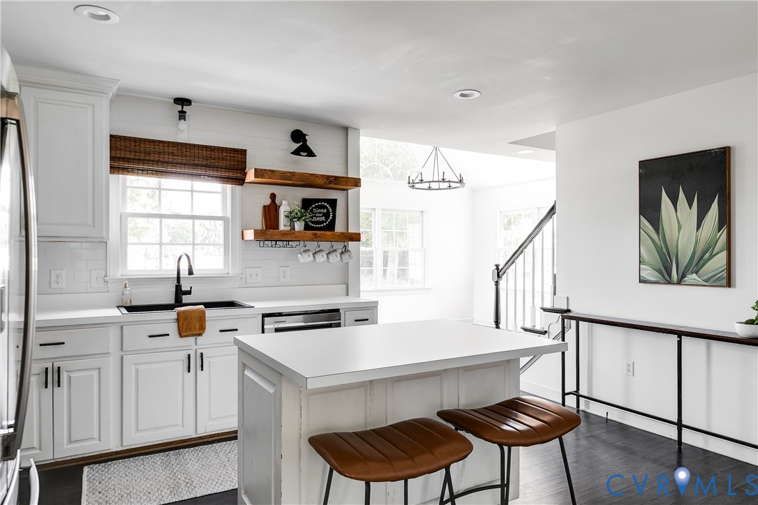 16044 Parsons Road Beaverdam, VA 23015 - Photo 16 of 44 a kitchen with a cabinets a sink and chairs