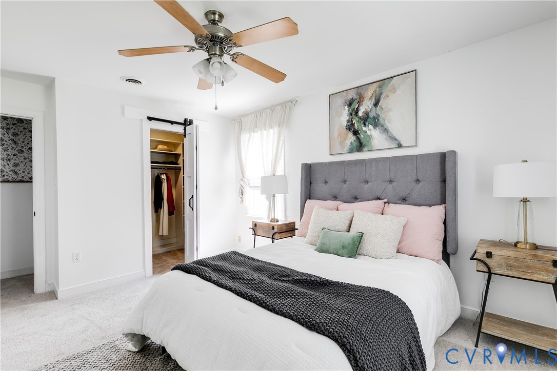 16044 Parsons Road Beaverdam, VA 23015 - Photo 22 of 44 a bedroom with a bed and a chandelier