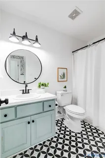 a bathroom with a sink toilet and a mirror