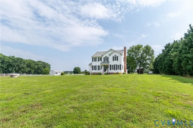 a view of a big room with a big yard and large trees