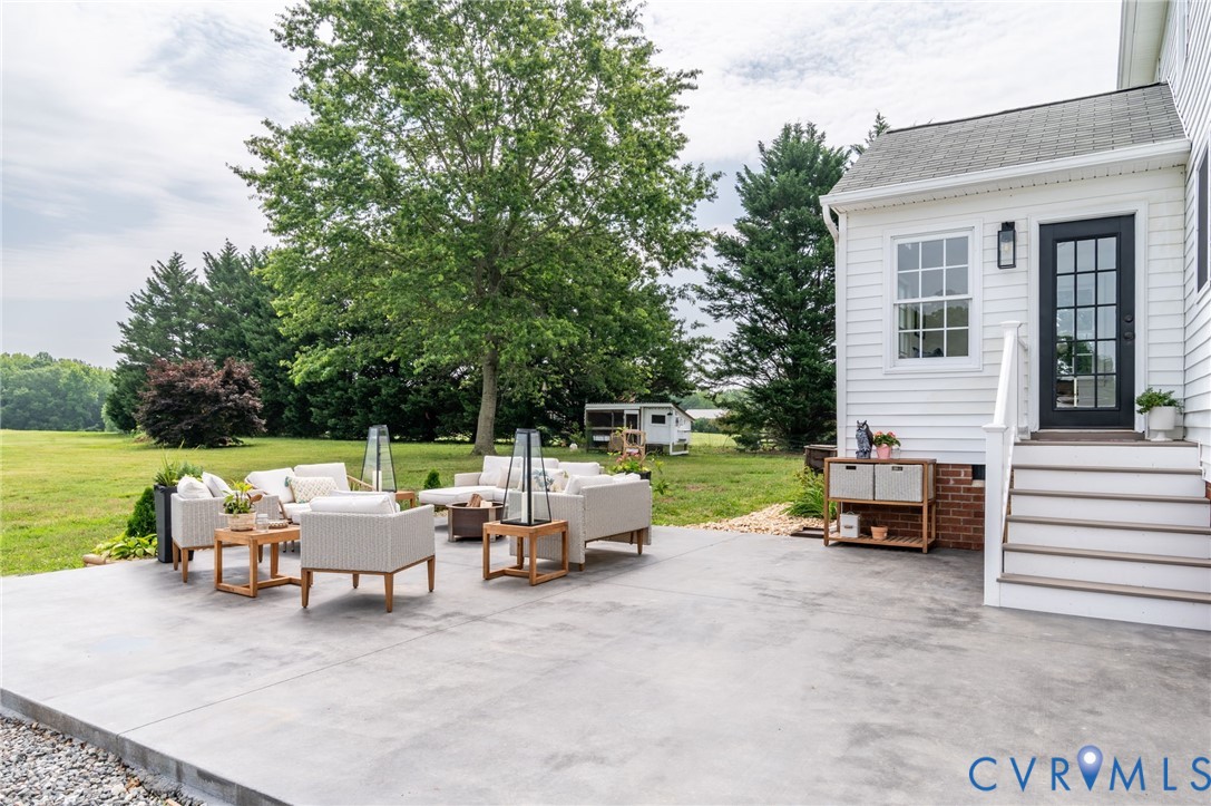16044 Parsons Road Beaverdam, VA 23015 - Photo 36 of 44 a view of a patio with a table and chairs next to a yard