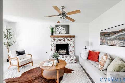 a living room with furniture and a fireplace