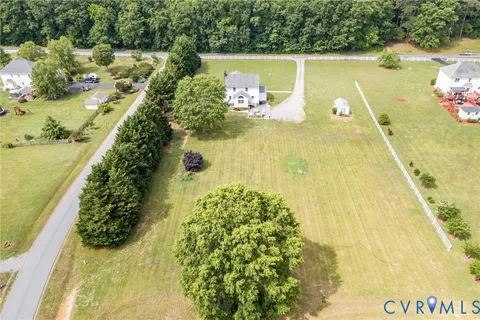 a aerial view of a house with a yard table and chairs