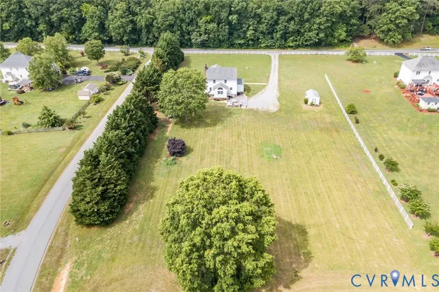 a aerial view of a house with a yard table and chairs