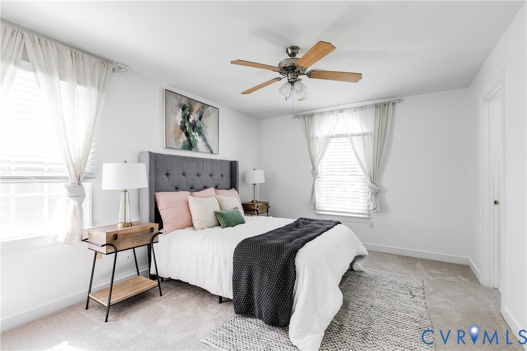 16044 Parsons Road Beaverdam, VA 23015 - Photo 7 of 44 a bedroom with a large bed and a chandelier