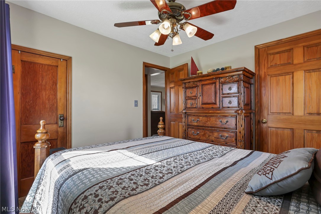 5502 Dutch Ridge Road New Straitsville, OH 43766 - Photo 25 of 49 Bedroom featuring ceiling fan and a textured ceiling