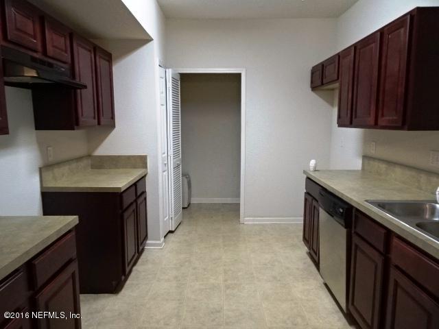 3631 Kirkpatrick Circle, Unit 6 Jacksonville, FL 32210 - Photo 3 of 14 a kitchen with stainless steel appliances granite countertop a sink stove and refrigerator
