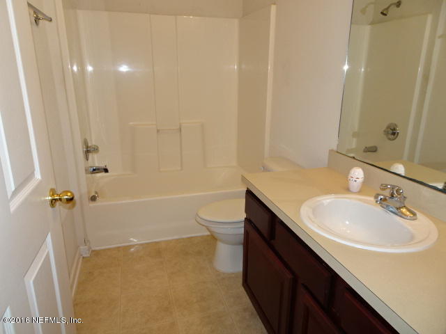 3631 Kirkpatrick Circle, Unit 6 Jacksonville, FL 32210 - Photo 7 of 14 a bathroom with a sink a toilet and shower