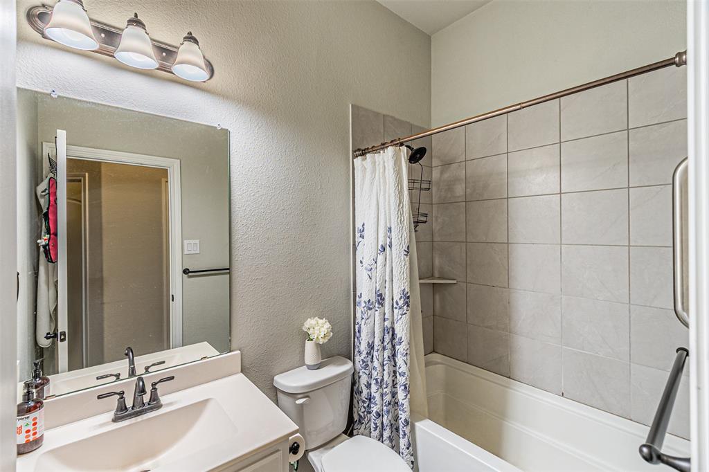 7201 Windy Ridge Drive Fort Worth, TX 76123 - Photo 11 of 36 a bathroom with a sink toilet and shower