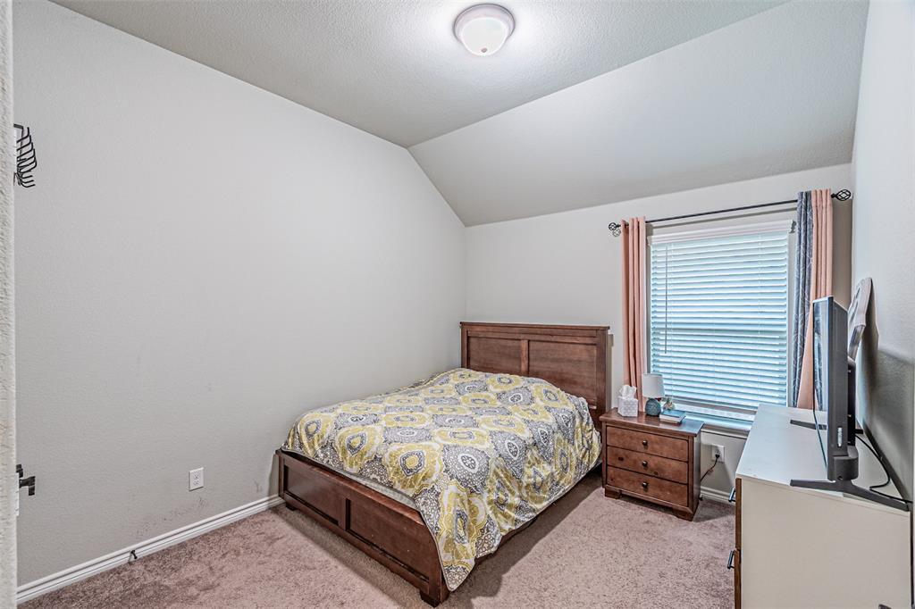 7201 Windy Ridge Drive Fort Worth, TX 76123 - Photo 13 of 36 a bedroom with a bed and a flat tv screen on dresser