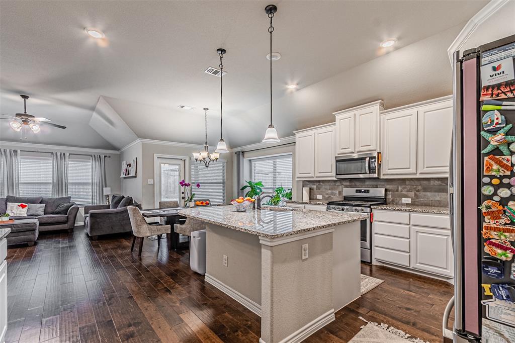 7201 Windy Ridge Drive Fort Worth, TX 76123 - Photo 17 of 36 a kitchen with a sink stove and cabinets