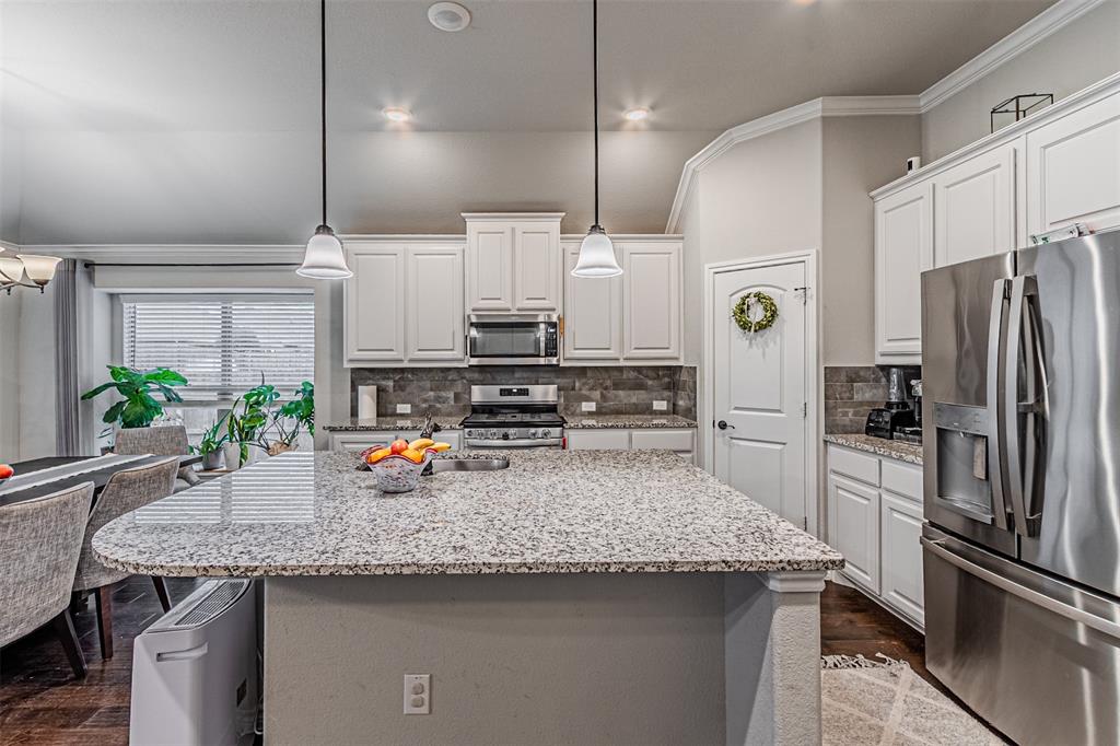 7201 Windy Ridge Drive Fort Worth, TX 76123 - Photo 18 of 36 a kitchen with stainless steel appliances a sink a stove and refrigerator