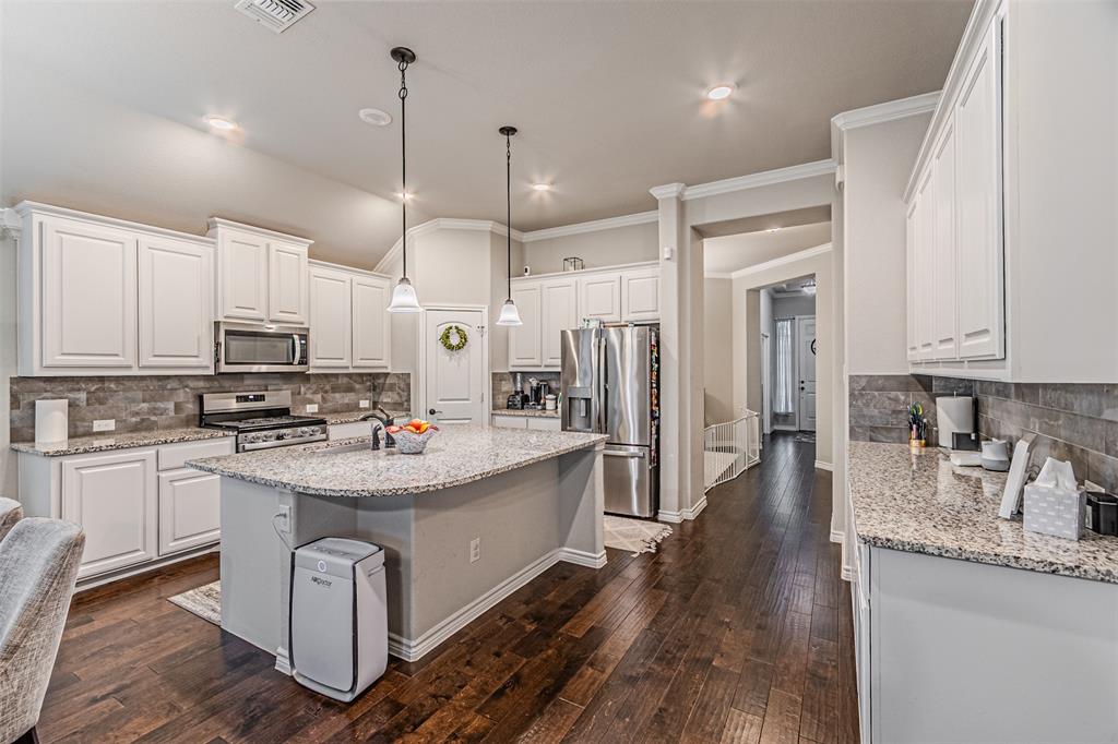 7201 Windy Ridge Drive Fort Worth, TX 76123 - Photo 19 of 36 a kitchen with counter top space a sink appliances and cabinets