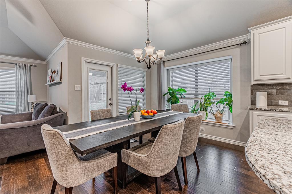 7201 Windy Ridge Drive Fort Worth, TX 76123 - Photo 21 of 36 a dining room with furniture a chandelier and wooden floor