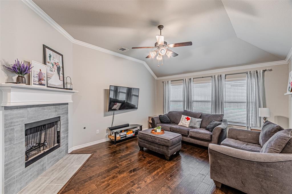 7201 Windy Ridge Drive Fort Worth, TX 76123 - Photo 23 of 36 a living room with furniture wooden floor and a fireplace