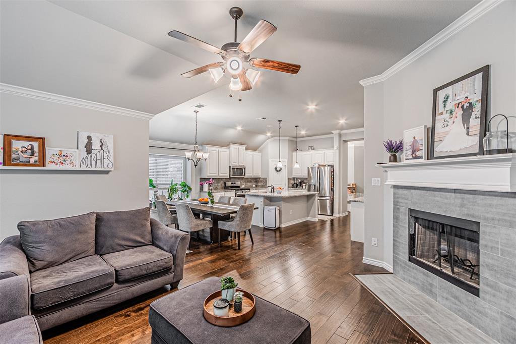 7201 Windy Ridge Drive Fort Worth, TX 76123 - Photo 25 of 36 a living room with furniture kitchen view and a fireplace