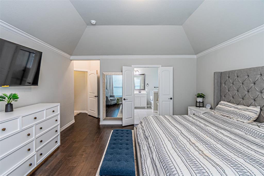 7201 Windy Ridge Drive Fort Worth, TX 76123 - Photo 27 of 36 a bedroom with a large bed and flat tv screen on dresser