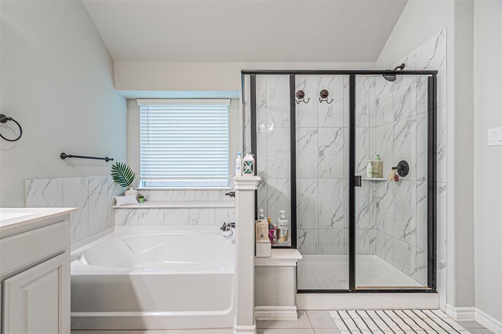 7201 Windy Ridge Drive Fort Worth, TX 76123 - Photo 29 of 36 a bathroom with a shower and a bathtub